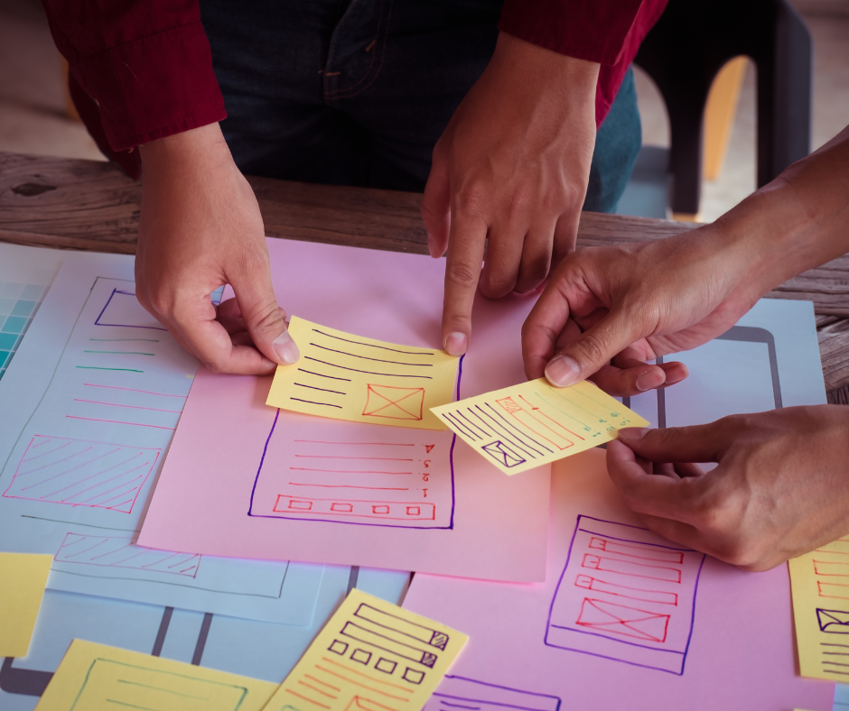 2 People planning out a website with sticky notes