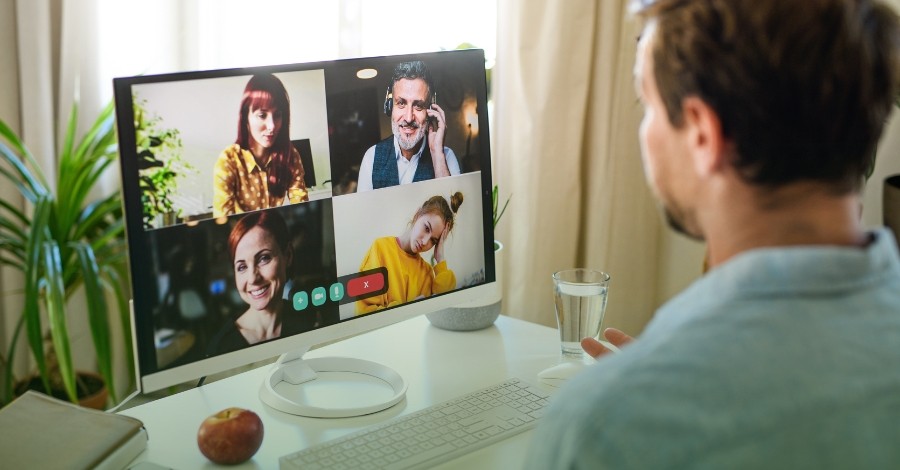 Man on group video call working remotely