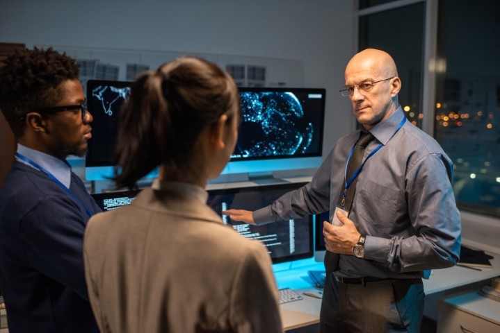 Director of software company giving instructions to his subordinates