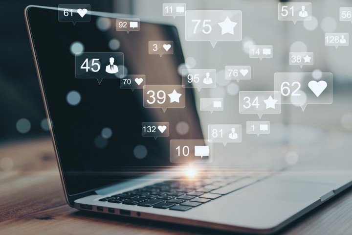 Computer surrounded with social media notifications